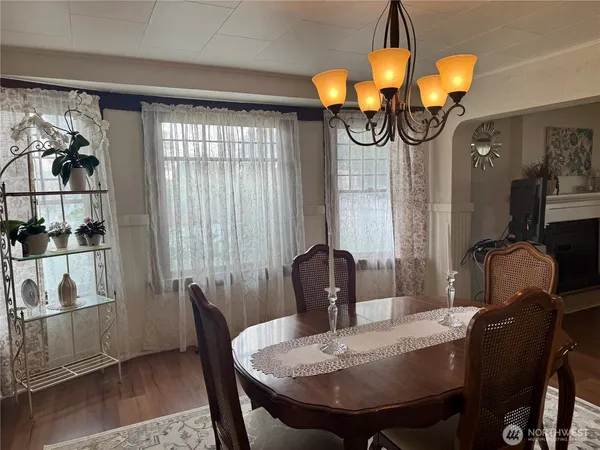 a view of a dining room with furniture and chandelier