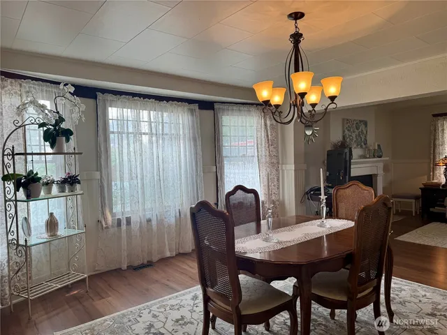 a dining room with furniture a chandelier and window