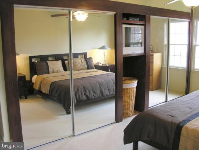 12300 Coleraine Court Reston, VA 20191 - Photo 14 of 28 a bedroom with a bed and a night stand