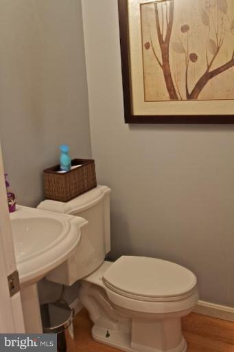12300 Coleraine Court Reston, VA 20191 - Photo 7 of 28 a white toilet sitting next to a white sink and vanity