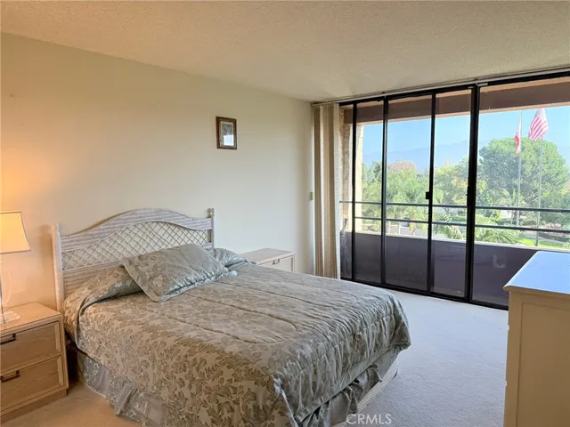 a bedroom with a large bed and a large window