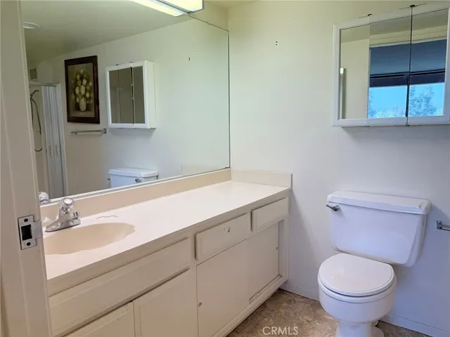 a bathroom with a sink toilet and window