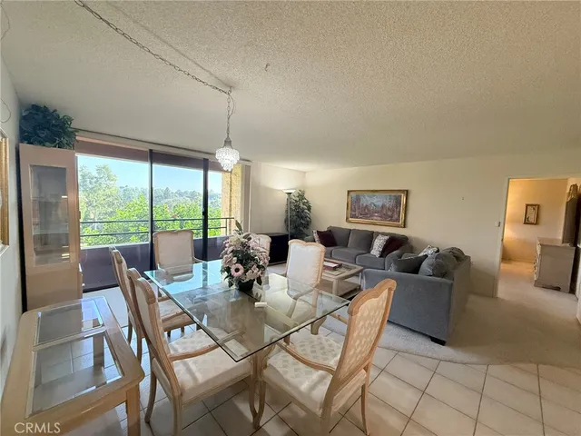 a dining room with furniture and large windows