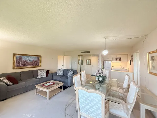 a living room with furniture a rug and a painting