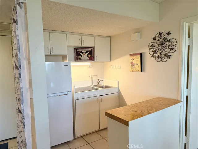 a room with a refrigerator and a sink