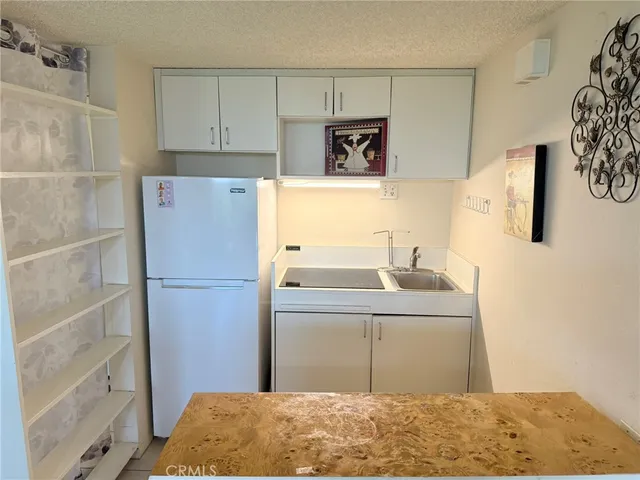 a kitchen with a sink and a refrigerator