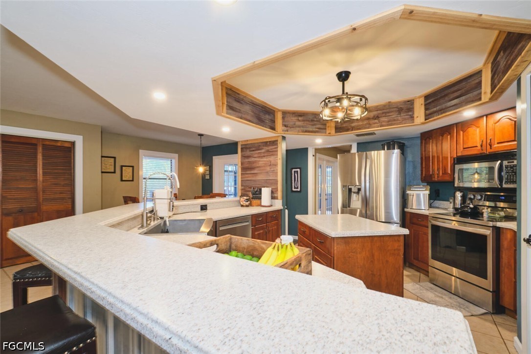 710-740 Evans Road LaBelle, FL 33935 - Photo 10 of 50 a large kitchen with kitchen island a stove a sink a dining table and chairs