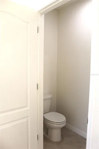 a white toilet sitting next to a white sink