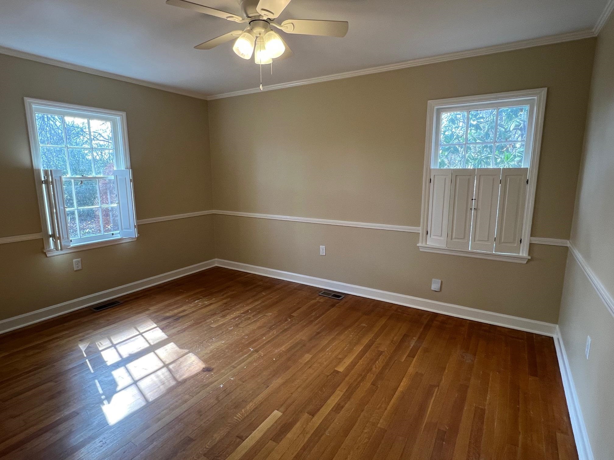 262 East Poplar Avenue Collierville, TN 38017 - Photo 11 of 19 a view of empty room with wooden floor and fan
