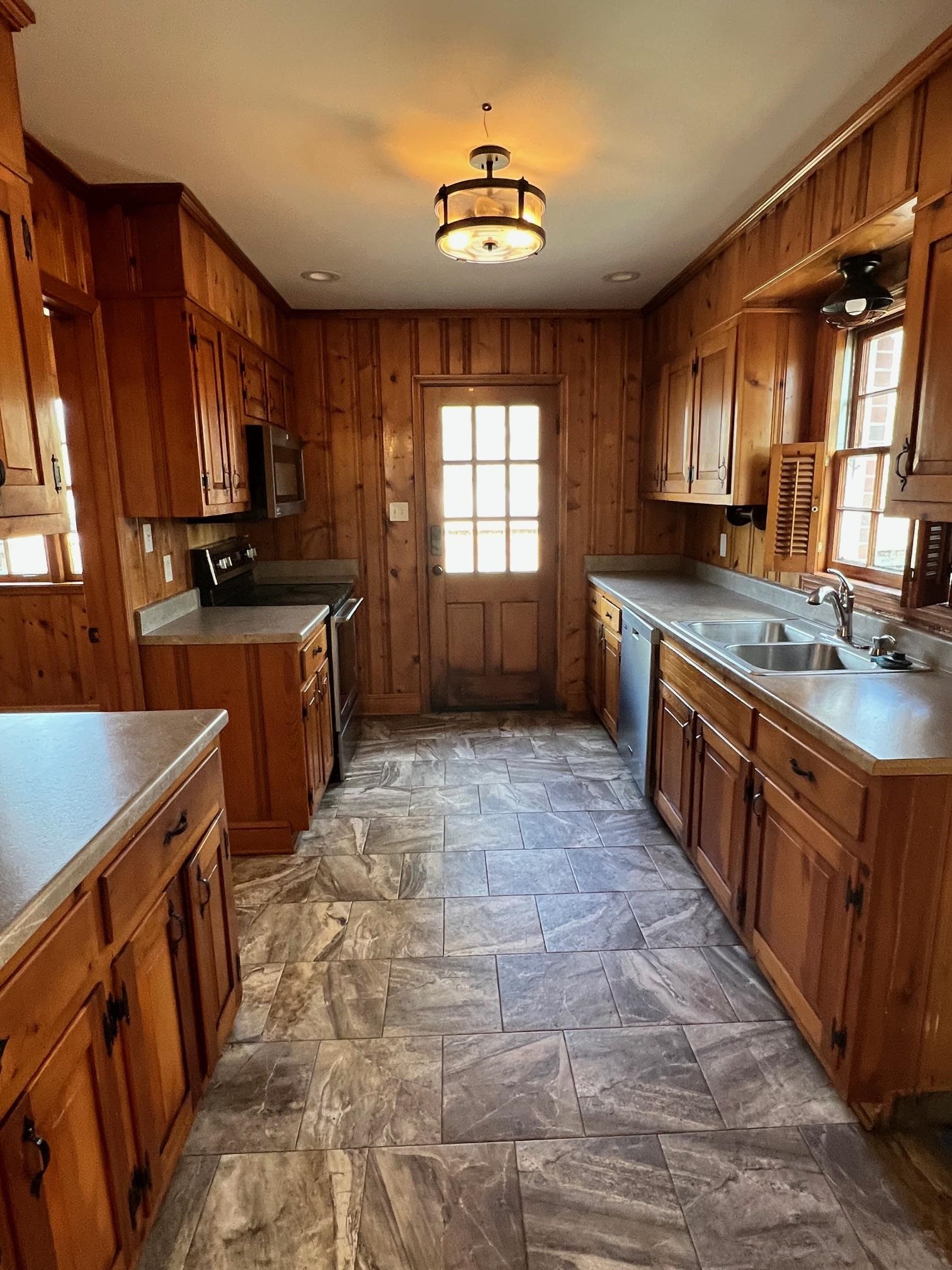262 East Poplar Avenue Collierville, TN 38017 - Photo 4 of 19 a kitchen with stainless steel appliances granite countertop a stove a sink dishwasher and a refrigerator