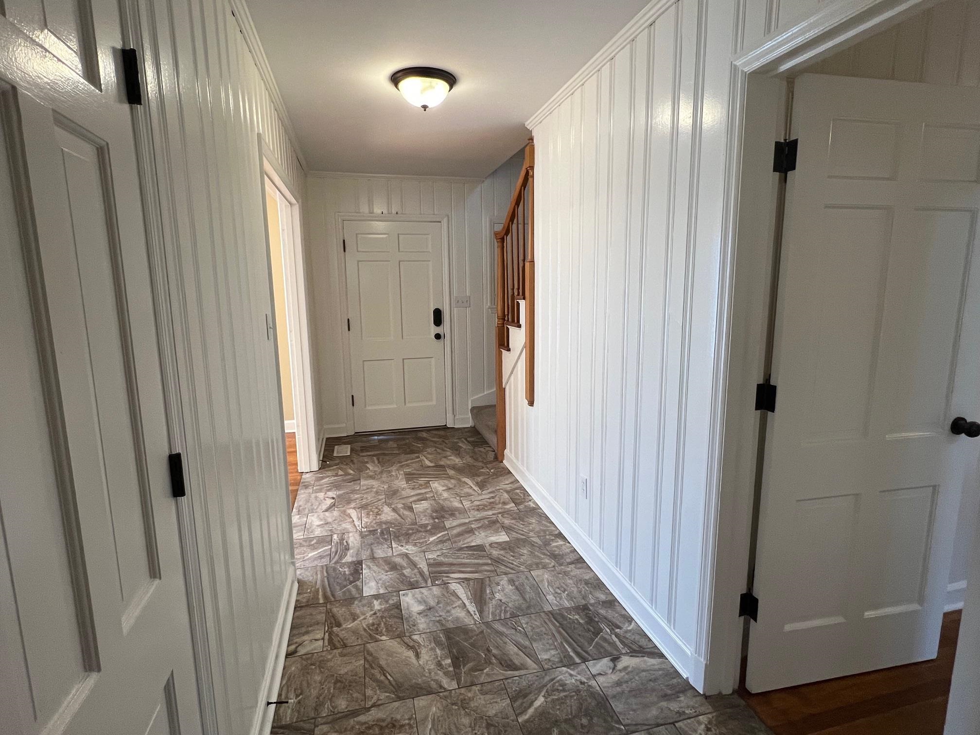 262 East Poplar Avenue Collierville, TN 38017 - Photo 7 of 19 a view of a hallway with a wooden door