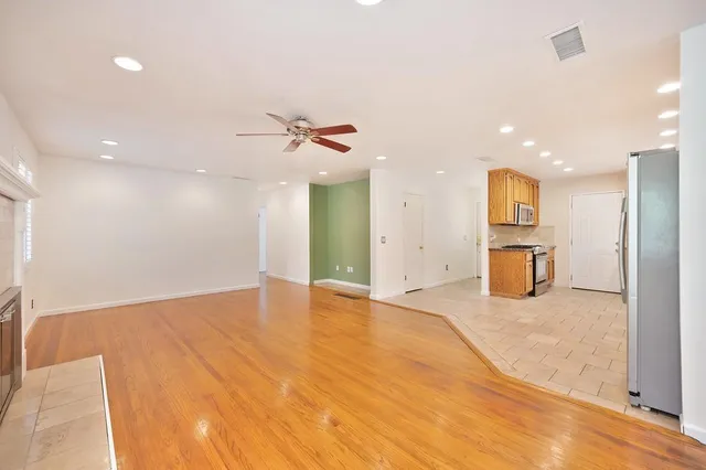 a view of an empty room with a kitchen