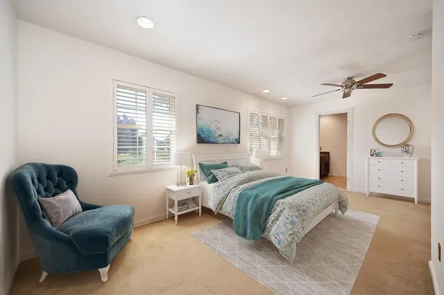 a bedroom with a bed couch and window