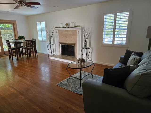 a living room with furniture a fireplace and a table