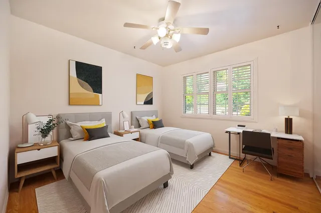 a bedroom with two beds and a table