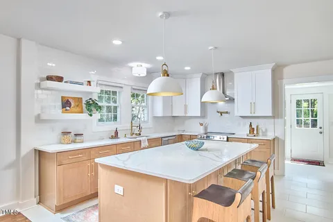 a kitchen with a sink a counter top space and cabinets