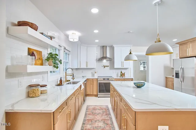 a kitchen with a sink a stove and chairs