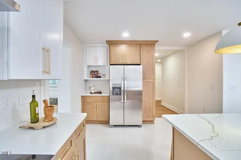 a kitchen with refrigerator and cabinets