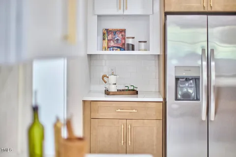 a kitchen with a refrigerator and cabinets