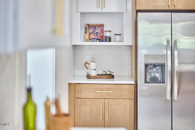 a kitchen with a refrigerator and cabinets