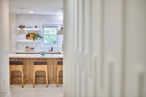 a kitchen with a sink cabinets and window