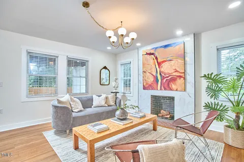 a living room with fireplace furniture and a flat screen tv