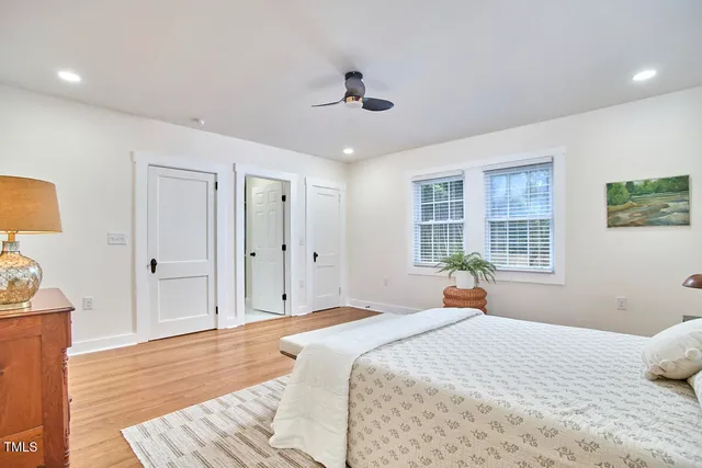 a bedroom with a bed and wooden floor