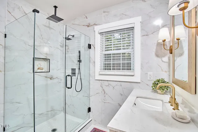 a bathroom with a tub shower and a sink