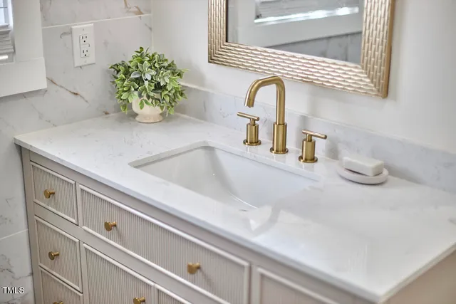 a close view of sink and a vanity in a bathroom