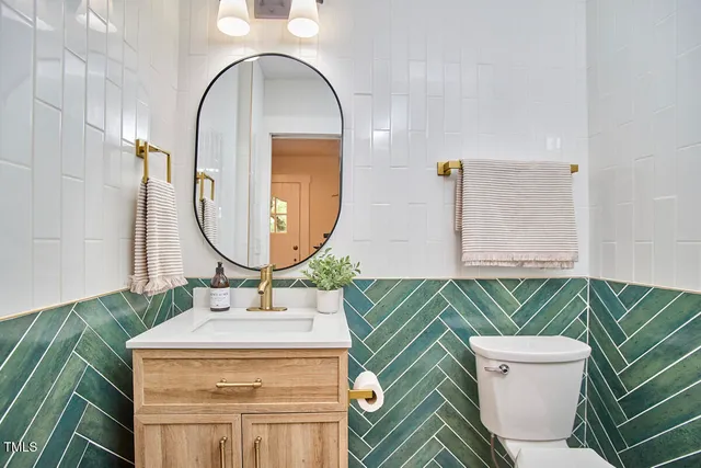 a bathroom with a sink a mirror and a toilet