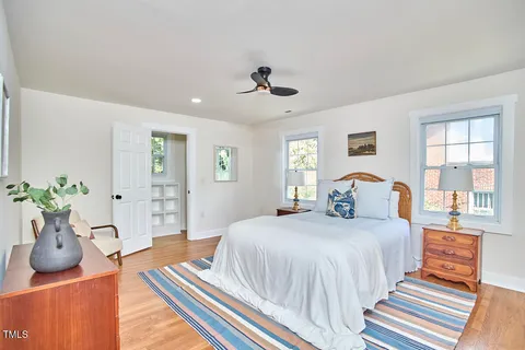 a bedroom with bed and wooden floor