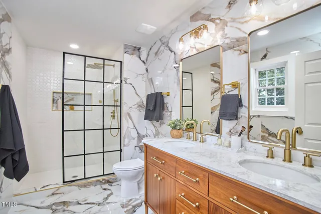 a bathroom with a double vanity sink mirror and shower