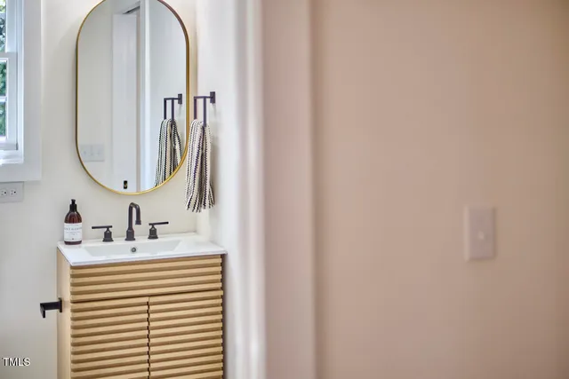 a bathroom with a sink tub and a mirror