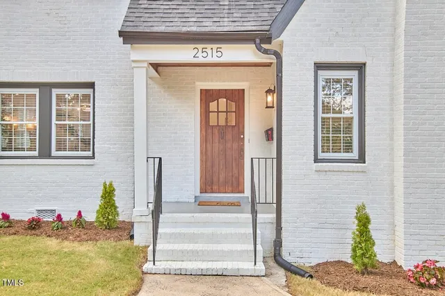 a front view of a house with a potted plant