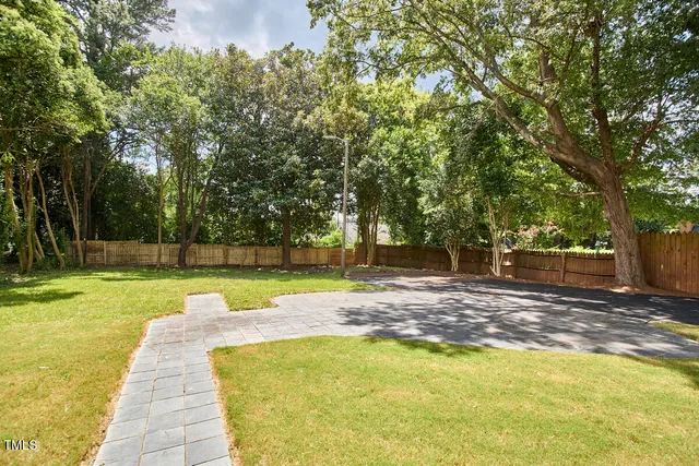 a view of a backyard with swimming pool