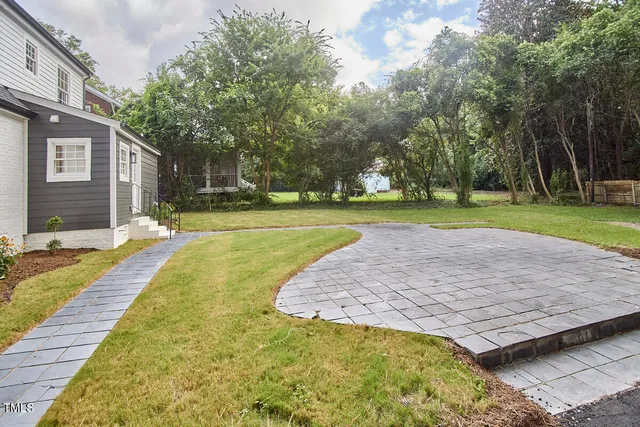a view of a house with pool and sitting area
