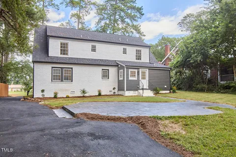 a front view of a house with yard and green space