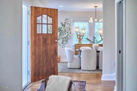 a view of entryway with furniture and chandelier