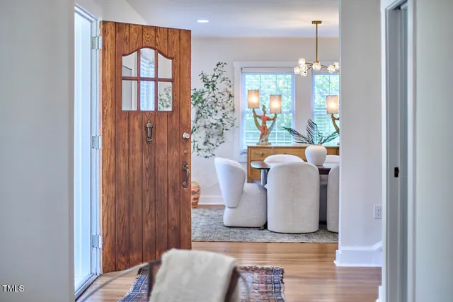 a view of entryway with furniture and chandelier