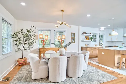 a living room with fireplace furniture and a wooden floor