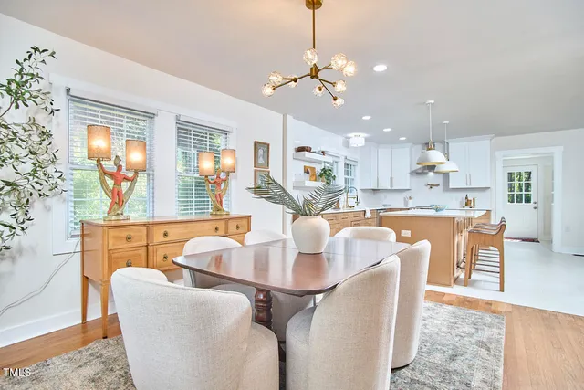 a living room with kitchen island furniture and a chandelier