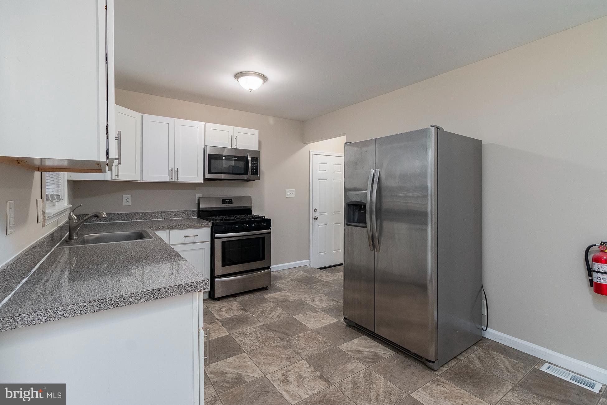 205 Starling Lane Mount Holly, NJ 08060 - Photo 7 of 21 a kitchen with granite countertop a refrigerator and a sink