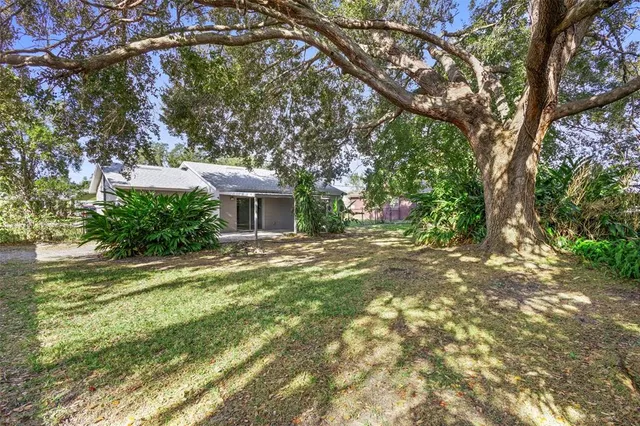 a view of house with backyard space and garden