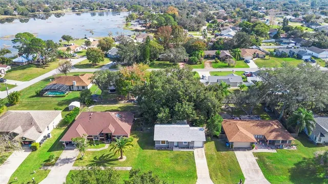 an aerial view of a house with a swimming pool yard and outdoor seating