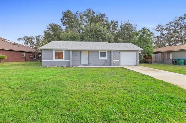 a view of house that has a yard