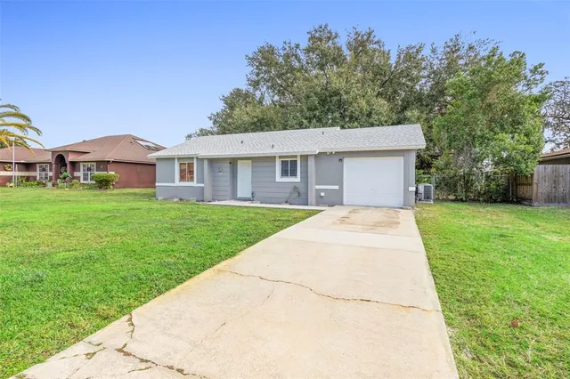 a view of house with a yard