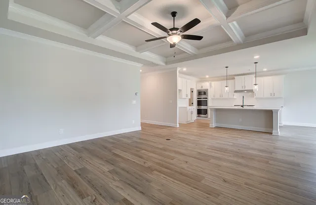 a view of large kitchen with granite countertop stainless steel appliances sink and cabinets