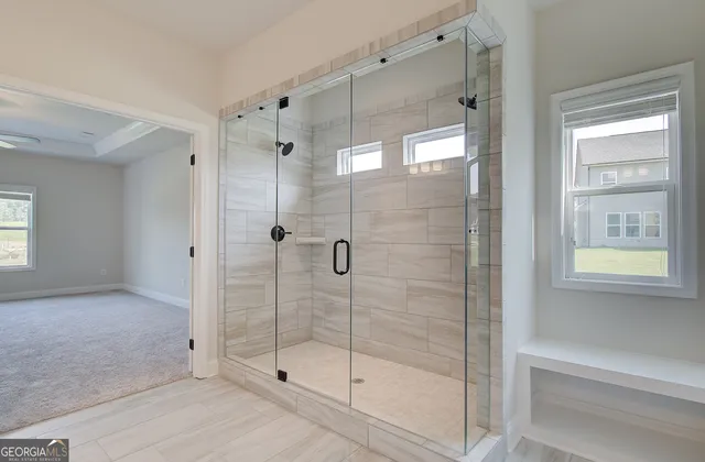 an empty room with a window and a fan