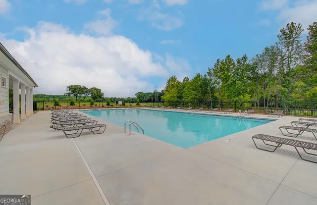 a view of a lake with couches in the patio