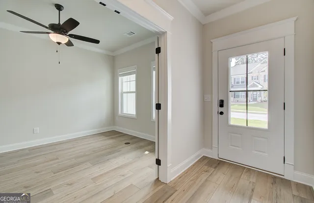 a view of a hallway with wooden floor and closet